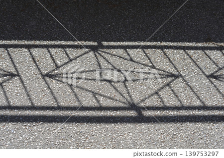 Geometric Shadow of a Fence on Asphalt Geometric Shadow of a Fence on Asphalt 139753297