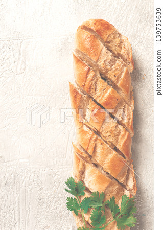 garlic bread,baguette with garlic butter and herbs, on a light table, top view, garlic bread,baguette with garlic butter and herbs, on a light table, top view, 139753639