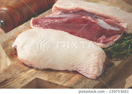 Fresh raw duck breast, on a wooden chopping board, top view, no people, Fresh raw duck breast, on a wooden chopping board, top view, no people, 139753681