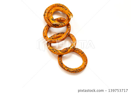 Floating bagels with poppy seeds on white background Floating bagels with poppy seeds on white background 139753717