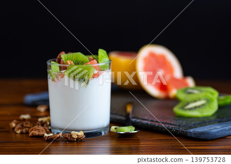 healthy probiotic yogurt with fruits and walnuts on table healthy probiotic yogurt with fruits and walnuts on table 139753728