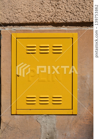 Yellow gas meter box on a building facade Yellow gas meter box on a building facade 139753862