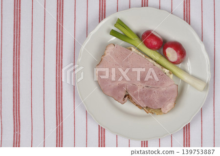 Smoked ham slice with spring onion and radishes Smoked ham slice with spring onion and radishes 139753887