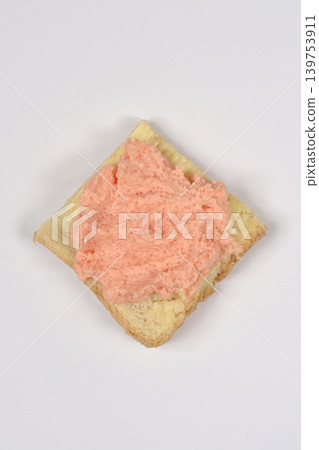 Salmon and fish roe spread on a slice of bread Salmon and fish roe spread on a slice of bread 139753911