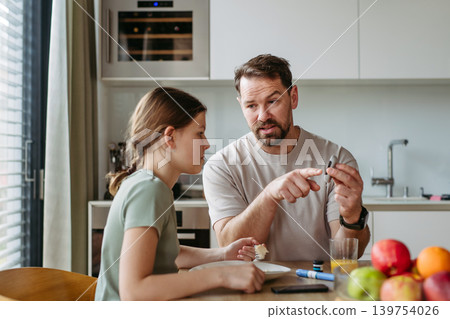 Parent helping diabetic daughter understand nutrition and sugar content. Parent helping diabetic daughter understand nutrition and sugar content. 139754026