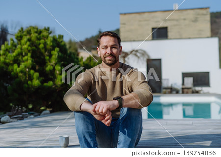 Man enjoying warm spring sunlight on face while standing outside. Man enjoying warm spring sunlight on face while standing outside. 139754036