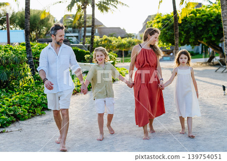 Parents and kids spending summer vacation in tropical beach resort. 139754051