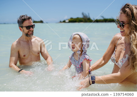 Family enjoying tropical beach vacation at luxury resort. Family enjoying tropical beach vacation at luxury resort. 139754060