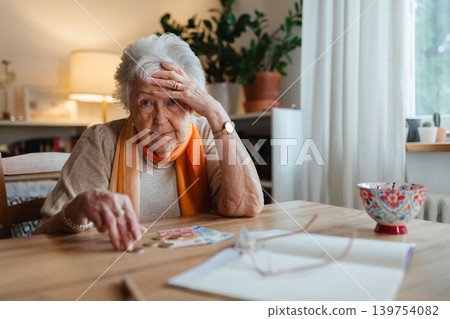 Social worker helping elderly lady with managing her finances, counting banknotes. Social worker helping elderly lady with managing her finances, counting banknotes. 139754082