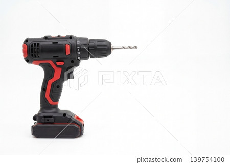 A modern cordless screwdriver with a thin drill bit, isolated on a light background with plenty of space for text. Suitable for repair, construction, installation and DIY topics. A modern cordless screwdriver with a thin drill bit, isolated on a light background with plenty of space for text. Suitable for repair, construction, installation and DIY topics. 139754100