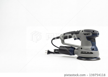 Corded electric orbital sander with dust collection canister and abrasive pad isolated on white background. Professional woodworking, surface finishing, renovation and DIY tool concept. Corded electric orbital sander with dust collection canister and abrasive pad isolated on white background. Professional woodworking, surface finishing, renovation and DIY tool concept. 139754118