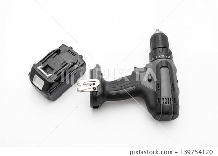 Cordless drill driver with removable battery pack isolated on white background. Portable power tool for construction, repair, installation, assembly, woodworking and DIY projects. Cordless drill driver with removable battery pack isolated on white background. Portable power tool for construction, repair, installation, assembly, woodworking and DIY projects. 139754120