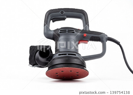 Powerful random orbital sander with sanding pad and dust bag isolated on white background. Electric tool for woodworking, surface finishing, renovation, repair, polishing and workshop tasks. 139754138