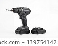 Modern cordless drill with drill bit and extra battery pack isolated on white background. Professional power tool for drilling, repair, construction, installation, woodworking and DIY use. 139754142