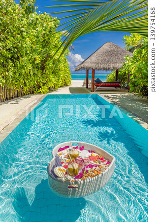 Famous luxury tourism couple honeymoon scenic morning sunlight floating breakfast tray tropical resort swimming pool breathtaking stunning dreamy serene paradise exotic romantic vacation destination 139754168