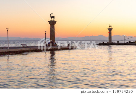 Deer statues and marina harbor at sunrise in Rhodes Old Town Greece Deer statues and marina harbor at sunrise in Rhodes Old Town Greece 139754250