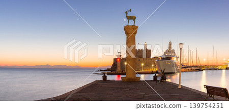 Deer statues and marina harbor at sunrise in Rhodes Old Town Greece Deer statues and marina harbor at sunrise in Rhodes Old Town Greece 139754251