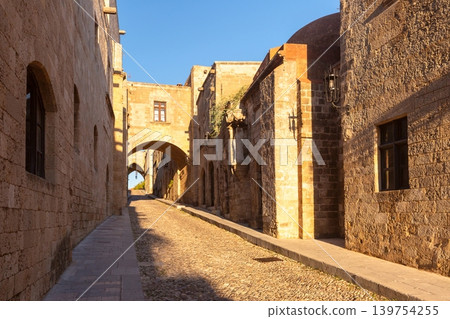 Narrow stone street with arches in Rhodes Old Town Greece Narrow stone street with arches in Rhodes Old Town Greece 139754255