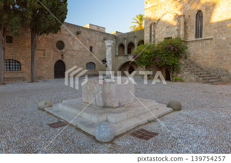 Historic courtyard with stone fountain in Rhodes Old Town fortress Greece Historic courtyard with stone fountain in Rhodes Old Town fortress Greece 139754257