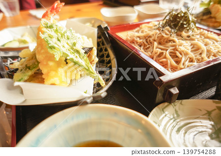 A Japanese-style lunch featuring freshly fried tempura and cold soba noodles. A Japanese-style lunch featuring freshly fried tempura and cold soba noodles. 139754288