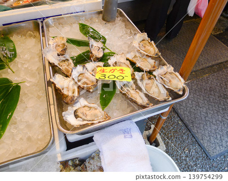 A market scene with rows of fresh raw oysters. 139754299