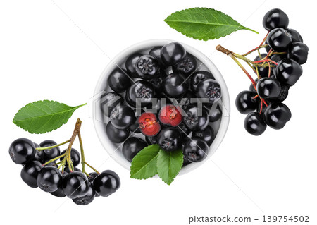 Chokeberry with leaf in a ceramic bowl isolated on white background. Black aronia. Top view. Flat lay Chokeberry with leaf in a ceramic bowl isolated on white background. Black aronia. Top view. Flat lay 139754502