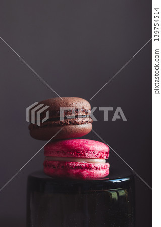 Two French macarons on dark background. Two French macarons on dark background. 139754514
