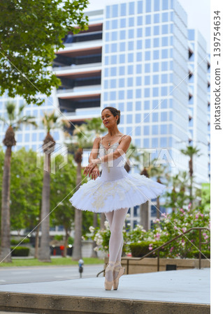 Ballerina standing on pointe in modern city plaza Ballerina standing on pointe in modern city plaza 139754634