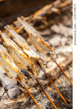 Salt-grilled river fish cooked over a hearth, giving it a fragrant aroma. Salt-grilled river fish cooked over a hearth, giving it a fragrant aroma. 139754675