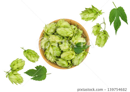 Hop cones in wooden bowl isolated on white background. Beer brewing ingredients. Top view. Flat lay 139754682