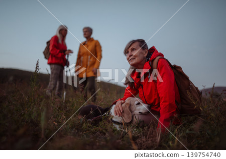 Senior female friends exploring nature together during golden hour. Senior female friends exploring nature together during golden hour. 139754740