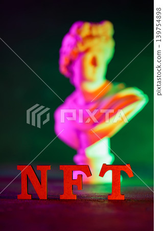 NFT red letters with blurred classical sculpture bust and colorful neon gradient lighting NFT red letters with blurred classical sculpture bust and colorful neon gradient lighting 139754898