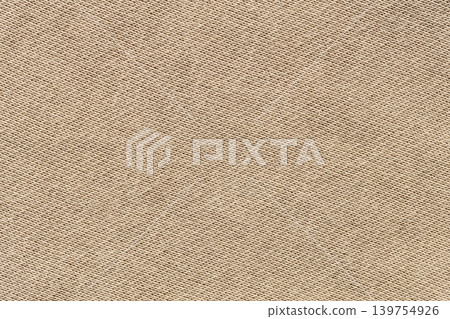 Beige woven canvas fabric texture background with diagonal pattern close-up Beige woven canvas fabric texture background with diagonal pattern close-up 139754926
