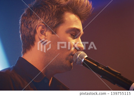 Singing, man and microphone for stage performance at concert with sound equipment for music and voice. Audio. technology and jazz musician and singer in theater, event or talent at karaoke night Singing, man and microphone for stage performance at concert with sound equipment for music and voice. Audio. technology and jazz musician and singer in theater, event or talent at karaoke night 139755115