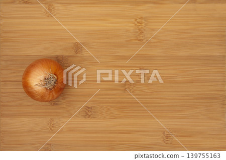 Onion on Bamboo Cutting Board. Onion on Bamboo Cutting Board. 139755163