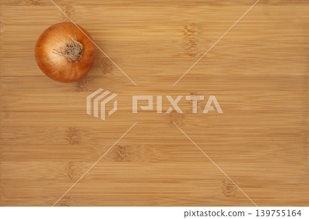 Onion on Bamboo Cutting Board. Onion on Bamboo Cutting Board. 139755164