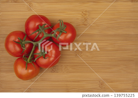 Fresh Tomato on Wooden Bamboo Kitchen Board. Fresh Tomato on Wooden Bamboo Kitchen Board. 139755225