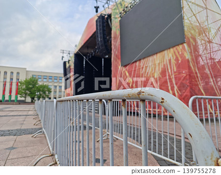 Metal crowd control barrier in front of an outdoor concert stage 139755278
