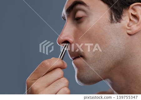 Nose hair, cleaning and man with tweezers and pain from plucking in studio background or mockup. Beauty, epilation and person with facial grooming routine and treatment for self care with tools Nose hair, cleaning and man with tweezers and pain from plucking in studio background or mockup. Beauty, epilation and person with facial grooming routine and treatment for self care with tools 139755347