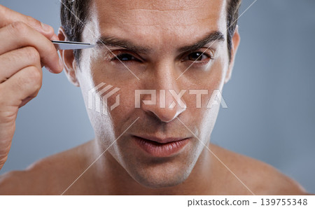 Man, portrait and tweezers for eyebrows or grooming for face clean, hygiene or grey background. Male person, pluck and hair removal for healthy morning routine or studio, treatment or mockup space Man, portrait and tweezers for eyebrows or grooming for face clean, hygiene or grey background. Male person, pluck and hair removal for healthy morning routine or studio, treatment or mockup space 139755348