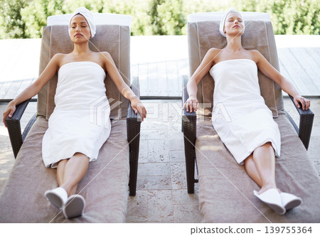 Women, spa and sleeping outdoor after massage, facial or hotel beauty treatment with rest. Relax, friends and nap from physical therapy, care and hospitality from skincare and wellness with peace 139755364