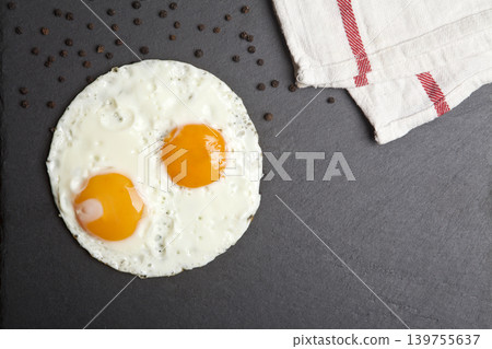 Serving fried eggs on a granite surface. Serving fried eggs on a granite surface. 139755637