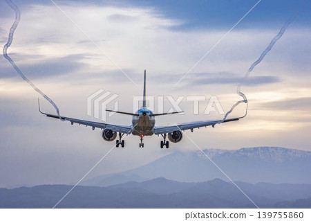 Sendai Airport at dusk: A plane landing and its vapor trail. Natori City, Miyagi Prefecture. Sendai Airport at dusk: A plane landing and its vapor trail. Natori City, Miyagi Prefecture. 139755860