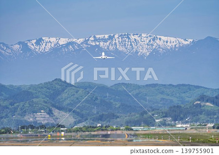 Sendai Airport on a sunny day: Zao mountain range and a plane taking off. Natori City, Miyagi Prefecture. Sendai Airport on a sunny day: Zao mountain range and a plane taking off. Natori City, Miyagi Prefecture. 139755901