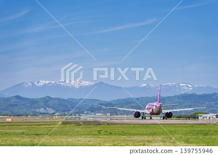 陽光明媚的仙台機場:藏王山脈和一架正在起飛的飛機。宮城縣名取市。 陽光明媚的仙台機場:藏王山脈和一架正在起飛的飛機。宮城縣名取市。 139755946