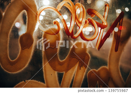 Urban graffiti on glass with warm cinematic bokeh lights. Grungy street art texture, abstract orange paint strokes, and nocturnal city atmosphere. Modern underground aesthetic for creative projects. Urban graffiti on glass with warm cinematic bokeh lights. Grungy street art texture, abstract orange paint strokes, and nocturnal city atmosphere. Modern underground aesthetic for creative projects. 139755987