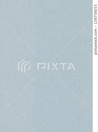 Solid light blue paper texture with a fine grain. Minimalist pastel background featuring a clean surface and a torn paper edge effect for creative craft projects. Textured craft paper, vertical shot. 139756055
