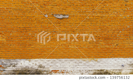 Rustic suburban structure with vertical strength. Weathered orange brick with moss at foundation line Rustic suburban structure with vertical strength. Weathered orange brick with moss at foundation line 139756132