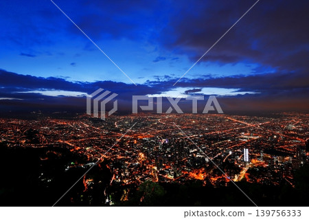 A breathtaking panoramic view of Bogotá, the capital of Colombia, at night, where roads of light intersect in the metropolis. A breathtaking panoramic view of Bogotá, the capital of Colombia, at night, where roads of light intersect in the metropolis. 139756333