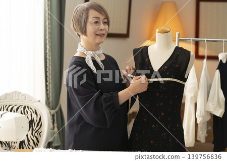 Senior female designers create clothes in their atelier. Senior female designers create clothes in their atelier. 139756836